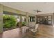 Inviting covered patio with stylish seating, lush landscaping, and a unique decorative lizard accent at 7508 N Ola Ave, Tampa, FL 33604