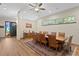 Dining room featuring a large wooden table, hardwood floors, and stained glass accents at 7508 N Ola Ave, Tampa, FL 33604