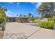 Charming home featuring a three-car garage and a welcoming covered porch area at 7508 N Ola Ave, Tampa, FL 33604