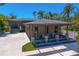 Charming home featuring a three-car garage and a welcoming covered porch area at 7508 N Ola Ave, Tampa, FL 33604