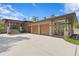 Charming home featuring a three-car garage and a welcoming covered porch area at 7508 N Ola Ave, Tampa, FL 33604