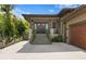Eye-level shot of an inviting home exterior featuring a stone stairway and mature landscaping at 7508 N Ola Ave, Tampa, FL 33604