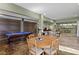 Open entertainment space with pool table, ping pong table, and dining area at 7508 N Ola Ave, Tampa, FL 33604