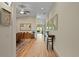 Hallway with hardwood floors, decorative furnishings, and a view into the dining and living areas at 7508 N Ola Ave, Tampa, FL 33604