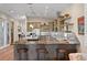 Kitchen with a large center island and breakfast bar featuring stainless steel appliances and open shelving at 7508 N Ola Ave, Tampa, FL 33604