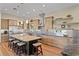 Kitchen featuring an island with bar seating, hardwood floors, and stainless steel appliances at 7508 N Ola Ave, Tampa, FL 33604