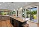 Kitchen island with barstool seating, offering a great view to the outside patio at 7508 N Ola Ave, Tampa, FL 33604