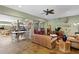 Spacious living room featuring sleek flooring, comfortable leather furnishings, and recreational elements at 7508 N Ola Ave, Tampa, FL 33604