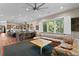 Open concept living room and kitchen area filled with natural light from the large windows and ample recessed lights at 7508 N Ola Ave, Tampa, FL 33604