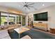 Inviting living room with sliding glass doors, a surfboard decor, and entertainment center at 7508 N Ola Ave, Tampa, FL 33604