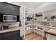 Organized pantry with dark cabinets and shelves stocked with cooking essentials and modern appliances at 7508 N Ola Ave, Tampa, FL 33604