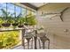Cozy patio with seating, hanging ferns, and a decorative marlin wall ornament at 7508 N Ola Ave, Tampa, FL 33604