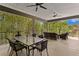 Spacious outdoor patio with dining and lounge areas, ideal for entertaining with green views at 7508 N Ola Ave, Tampa, FL 33604