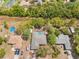 Aerial view of a home with a pool surrounded by lush greenery and neighboring properties at 7660 Holiday Dr, Spring Hill, FL 34606