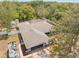 An aerial view reveals a home with a screened-in pool, a boat, and a spacious yard at 7660 Holiday Dr, Spring Hill, FL 34606