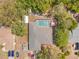 Aerial view of a single-Gathering home with a backyard pool, vehicles, and lush landscaping, showing the property layout at 7660 Holiday Dr, Spring Hill, FL 34606