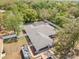 Aerial view of a house with a screened pool, a boat, a boat trailer, and lush green landscaping at 7660 Holiday Dr, Spring Hill, FL 34606