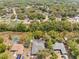 Aerial shot of property showcasing two pools, lush greenery, and surrounding neighborhood at 7660 Holiday Dr, Spring Hill, FL 34606