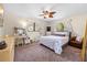 Well-lit bedroom featuring a decorative ceiling fan, cozy furniture and two windows at 7660 Holiday Dr, Spring Hill, FL 34606