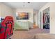 This bedroom includes a TV, a dresser, and a walk-in closet with a door at 7660 Holiday Dr, Spring Hill, FL 34606