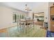 Open dining area with a table setting for six, adjacent to sliding glass doors and views of the pool at 7660 Holiday Dr, Spring Hill, FL 34606