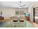 A bright dining area has a window view, table with chairs, and access to the screened pool at 7660 Holiday Dr, Spring Hill, FL 34606
