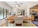 Bright dining room featuring an oversized table set for eight, sliding doors and backyard pool view at 7660 Holiday Dr, Spring Hill, FL 34606