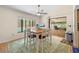 Bright dining room featuring an oversized table set for six, view of the backyard patio and stainless steel trash can at 7660 Holiday Dr, Spring Hill, FL 34606