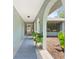 A view from the arched entryway, highlighting the covered walkway and inviting front door at 7660 Holiday Dr, Spring Hill, FL 34606