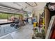 Spacious garage with an open door revealing a red truck and assorted equipment at 7660 Holiday Dr, Spring Hill, FL 34606