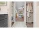 A hallway connects a bathroom to a bedroom, with views of the bedroom, walk-in closet, and bath at 7660 Holiday Dr, Spring Hill, FL 34606