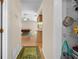 Hallway view of open-concept living space with hardwood floors, pool table, and ample lighting at 7660 Holiday Dr, Spring Hill, FL 34606