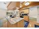 Well-lit kitchen with a marble-top island, stainless steel appliances, and dining area with a backyard pool view at 7660 Holiday Dr, Spring Hill, FL 34606