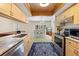 Well-equipped kitchen with stainless steel appliances, ample storage, and view of dining area and recreation space at 7660 Holiday Dr, Spring Hill, FL 34606