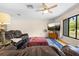Bright living room with ceiling fan, large window, and hardwood floors at 7660 Holiday Dr, Spring Hill, FL 34606