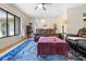 Spacious living area with hardwood floors, leather seating, and natural light through large window at 7660 Holiday Dr, Spring Hill, FL 34606