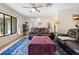 Bright living room features wood floors, ceiling fan, and large windows providing natural light at 7660 Holiday Dr, Spring Hill, FL 34606