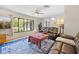 Comfortable living room with a large window, ceiling fan, and neutral wall paint at 7660 Holiday Dr, Spring Hill, FL 34606