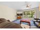 Bright living room with hardwood floors, ceiling fan and a large window at 7660 Holiday Dr, Spring Hill, FL 34606
