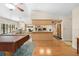 Open concept living space with pool table, dining area, kitchen, backyard pool and patio views at 7660 Holiday Dr, Spring Hill, FL 34606