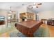 An open-concept living space includes a kitchen and dining area with seamless transition and views throughout the room at 7660 Holiday Dr, Spring Hill, FL 34606