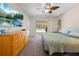 This bedroom offers a ceiling fan, TV, and sliding glass door access to a screened outdoor space with a pool view at 7660 Holiday Dr, Spring Hill, FL 34606
