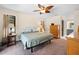 Cozy main bedroom with ceiling fan, dresser, and closet at 7660 Holiday Dr, Spring Hill, FL 34606