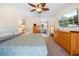 Main bedroom features a ceiling fan, dresser, and TV at 7660 Holiday Dr, Spring Hill, FL 34606