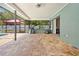 An ample, covered patio space featuring brick pavers, ideal for relaxing or entertaining outdoors at 7660 Holiday Dr, Spring Hill, FL 34606
