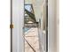View from inside a home through a door to the screened lanai enclosing the pool at 7660 Holiday Dr, Spring Hill, FL 34606