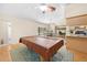 Open-concept living space with pool table, dining area, and a kitchen, creating a versatile and inviting atmosphere at 7660 Holiday Dr, Spring Hill, FL 34606