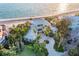 Stunning beachfront home boasts lush landscaping, a circular driveway, and breathtaking ocean views at 770 N Manasota Key Rd, Englewood, FL 34223