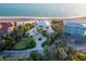 Gorgeous aerial view of a beachfront property with lush landscaping and direct beach access at 770 N Manasota Key Rd, Englewood, FL 34223