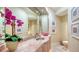 Elegant powder room featuring a marble countertop and unique floral arrangement at 770 N Manasota Key Rd, Englewood, FL 34223